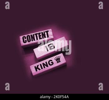 Content is king words on wooden blocks on dark grey background. Copywriting storytelling concept Stock Photo