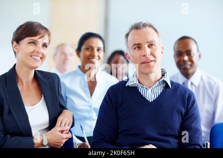 Executives enjoying presentation. View of executives listening to presentation. Stock Photo