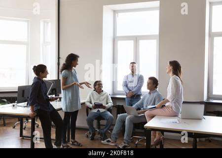 Young multiethnic business team brainstorming in project, sharing creative ideas Stock Photo