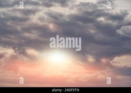 Dramatic sky and thunderclouds are illuminated by setting sun Stock Photo