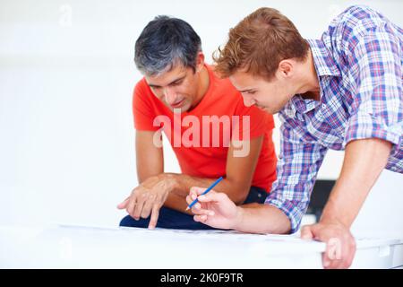Photographers working. Two male photographers in discussion during work. Stock Photo