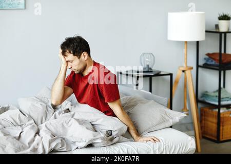 Mature man waking up in the morning in his bedroom Stock Photo
