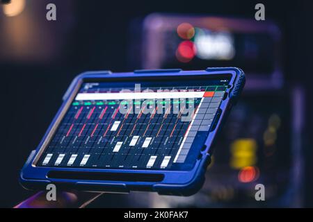 Remote control and sound settings from the tablet. Stock Photo