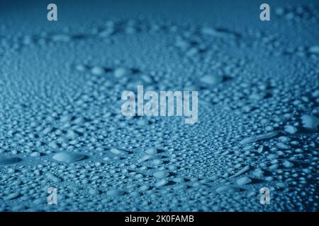 Blue drops of water, dew on smooth surface Stock Photo