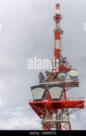 A part of communication tower with control devices and antennas, transmitters and repeaters for mobile communications and the Internet. Vertical view Stock Photo