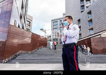 Bogota Colombia,Avenida El Dorado Calle 26,security guard walkie talkie using talking 2-way radio,Colombian Colombians Hispanic Hispanics South Americ Stock Photo