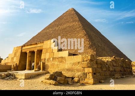The restored entrance to the mastaba of Seshemnefer IV with the pyramid of Khufu behind, Giza pyramid complex, Cairo, Egypt Stock Photo