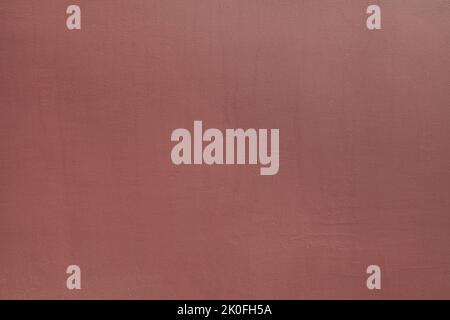 Rufous or dark brown wall, texture, background. The building wall, painted with water-based paint of dark-red color. Smooth (flat) surface Stock Photo