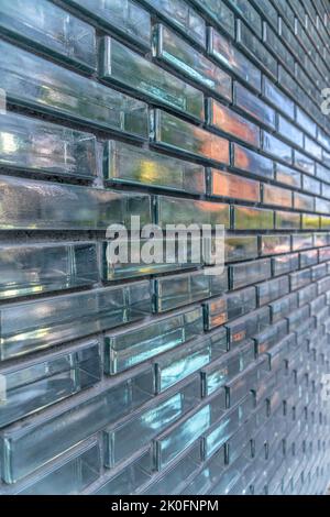 Austin, Texas- Close-up of a building wall with glass bricks in a running bond pattern. Building exterior with reflective glass wall. Stock Photo