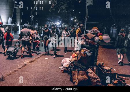 Trash can full of garbage in front of Stanley Park after Celebration of Light Show Stock Photo