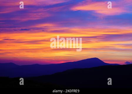 Amazing mountain sunset. Wild sunset colors of the sky. Pink, orange and red sky Stock Photo