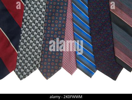 Variety of neck ties lined up in a row, striped and patterned. Isolated on white. Border. Stock Photo