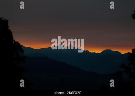 Vancouver, British Columbia, Canada. 10th Sep, 2022. A smoke filled sunset appears behind the Two Sisters (aka The Lions) on the North Shore Mountain in North Vancouver, British Columbia. (Credit Image: © Ryan Walter Wagner/ZUMA Press Wire) Stock Photo