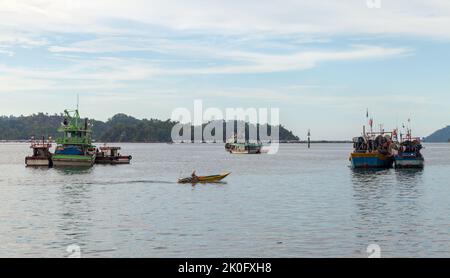 Kota Kinabalu, Malaysia - March 23, 2019: Fishing boats moored in bay of Kota Kinabalu on a sunny day Stock Photo