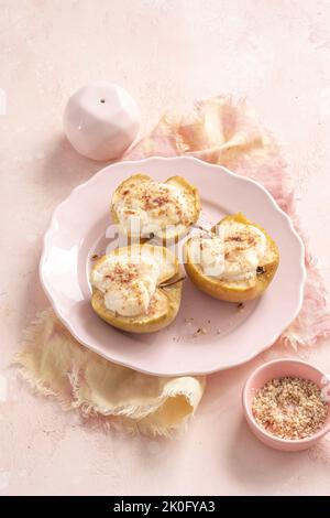 grilled pears baked with ricotta cheese and walnuts. honey topping Stock Photo