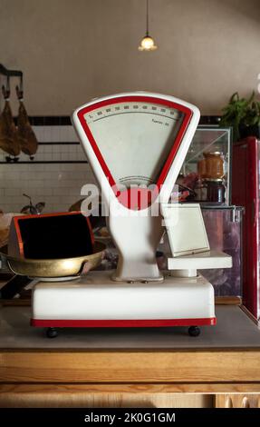 Old white scale over wooden grocery counter. Vintage background Stock Photo