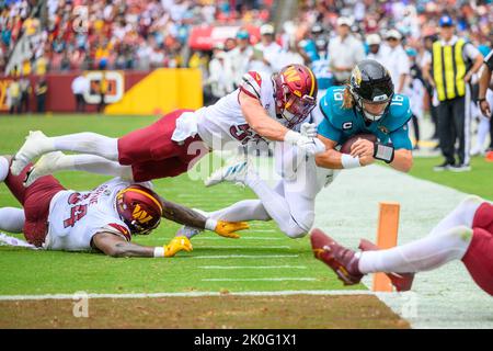 Landover, MD, USA. 11th Sep, 2022. Jacksonville Jaguars quarterback Trevor  Lawrence (16) is forced out of bounds near the goal line by Washington  Commanders defensive tackle Daron Payne (94) and Washington Commanders