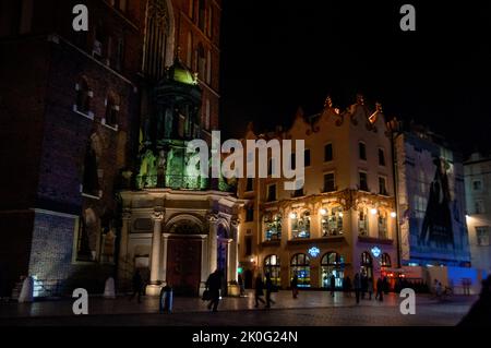 Front door of St. Mary's Basilica and the Hard Rock Cafe in Krakow, Poland. Stock Photo