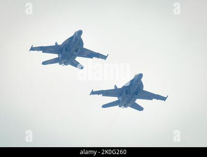 BALTIMORE (Sept. 10, 2022) - Two Boeing F/A-18E/F Super Hornets from Fighter Squadron Composite Twelve (VFC-12) perform a flyover above Baltimore’s Inner Harbor for Maryland Fleet Week and Flyover 2022. Maryland Fleet Week and Flyover is the city’s celebration of the sea services with this year marking the City of Baltimore's third time hosting Navy Fleet Week. (U.S. Navy photo by Mass Communication Specialist Petty Officer 3rd Class Oliver Serna) Stock Photo