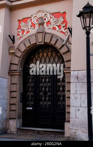 Eastern European Krakow arched doorway with bas-relief embellishment. Stock Photo