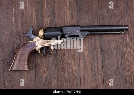 Old West gun - Percussion Army Revolver on wooden table Stock Photo