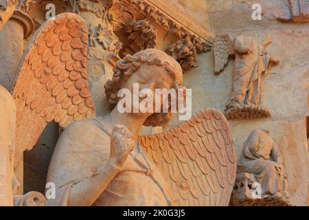 The Smiling Angel (Smile of Reims), carved between 1236-1245, on the north portal of the west facade of Reims Cathedral (Marne), France Stock Photo