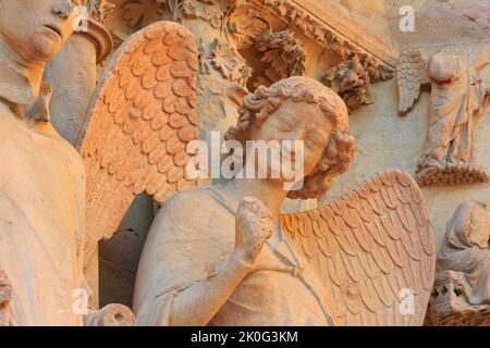 The Smiling Angel (Smile of Reims), carved between 1236-1245, on the north portal of the west facade of Reims Cathedral (Marne), France Stock Photo