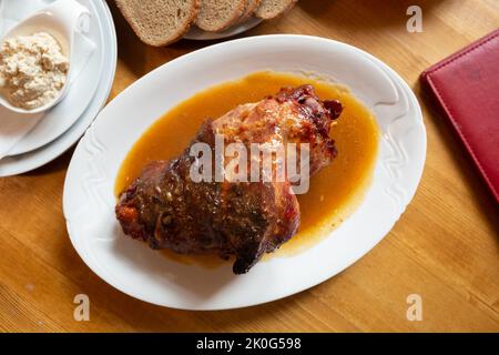 Delicious grilled knuckle of pork with horseradish and mustard.  Stock Photo