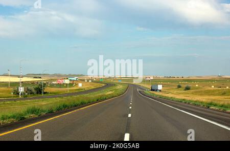 Middle of the road with center line dashes on Interstate Highway 94 showing little to no traffic on a summer evening in western, North Dakota Stock Photo