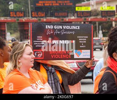 San Francisco, CA - June 4, 2022:  Wear Orange Stop Gun Violence March, participants marching to and across the Golden Gate Bridge holding signs deman Stock Photo