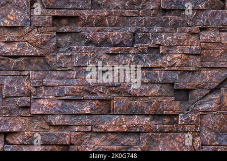 fake stone wall, plastic panel imitating natural slab wall brickwork Stock Photo