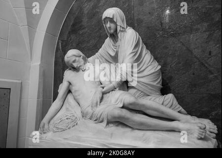 The Pietà – the Virgin Mary cradling the dead body of Jesus after it was removed from the cross. The Church of Saints Cosmas & Damian in Clervaux. Stock Photo