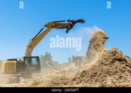 This is a piece of land that is being prepared for the building of a housing development using an industrial shredder machine to shred the roots into Stock Photo