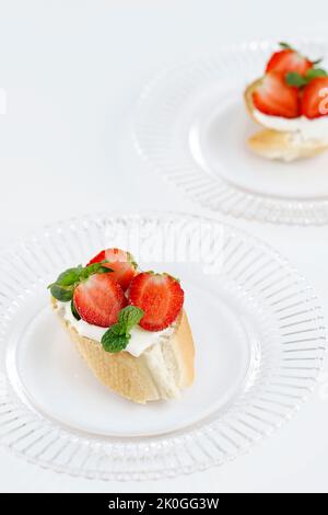 Sweet Strawberry Dessert with Cottage Cheese, Ricotta Cheese. Sandwich, Bruschetta, Snack, Appetizers with Strawberry and Mint Leaves. Stock Photo