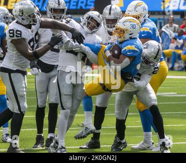 Inglewood, United States. 11th Sep, 2022. Most of the Las Vegas defense hoists Chargers' running back Austin Ekeler (30) for a no gain during the first half of a game between the Los Angeles Chargers and the Oakland Raiders at SoFi Stadium in Inglewood CA, Sunday September 11, 2022. Photo by Mike Goulding/UPI Credit: UPI/Alamy Live News Stock Photo