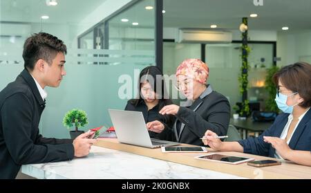 Group of Asian office business people working together in a modern co working space. Stock Photo