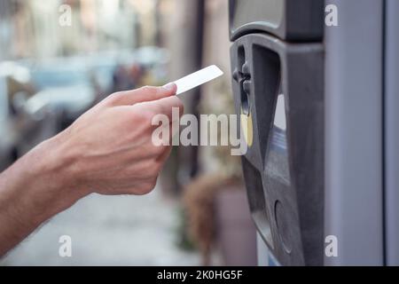Close up of a hand inserting a card to atm Stock Photo