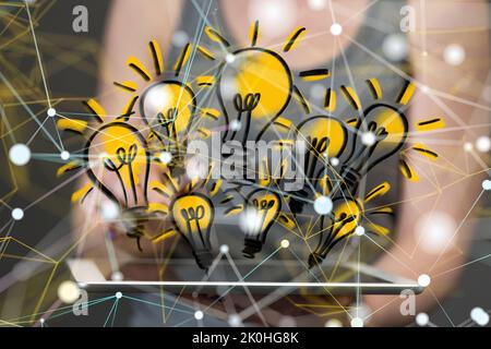The light bulbs popping over the tablet screen- creative ideas or solutions concept Stock Photo