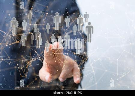 The hand pointing at the hovering people icons. Human resources concept. Stock Photo