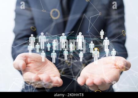 The people icons hovering above the hands. Stock Photo