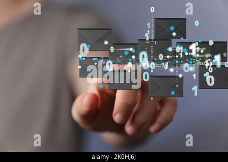 A finger pointing to 3d floating massage envelop icons - a concept of connection, networking Stock Photo