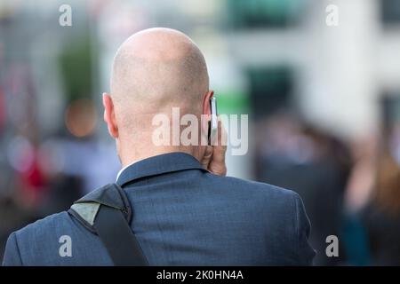 businessman with mobile phone on his ear makes a call Stock Photo