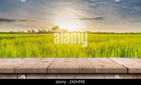 Wood table and rice field and sunrise blue sky with lens flare, display montage for product. Stock Photo