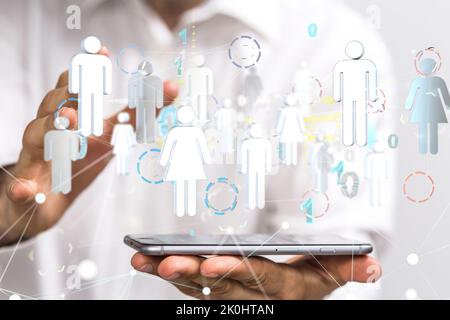 A man presenting the people icons over his phone Stock Photo