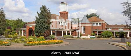 Well tended summer flowers & gardens around the South & East Chapel brick buildings at South Essex Crematorium Corbets Tey Upminster London England UK Stock Photo