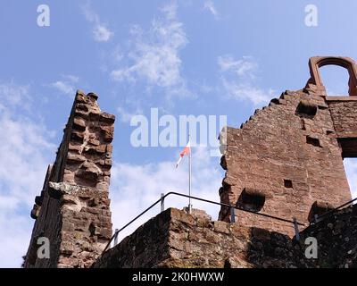 A low angle of a flag on the Nanstein Castle ruins in Landstuhl, Germany Stock Photo