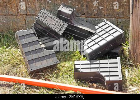 Super fast fibre optic high speed broadband black plastic cable junction boxes with lids to be installed outside dwelling for joint to home cable UK Stock Photo