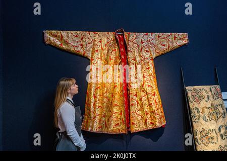 London UK. 12 September 2022.  A central Asianb silk abd metallic man's Chapan Late 19th century, possibly Bukhara Estimate USD 1,500-2,500. Highlights from the Ann & Gordon Getty Collection Ahead of being sold for charity during Four Day and Evening Sales in New York October 20-24 Credit: amer ghazzal/Alamy Live News Stock Photo