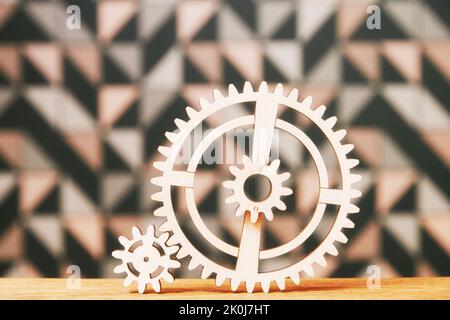 Big and small wooden gear wheels connected on the table. Puzzle games concept Stock Photo
