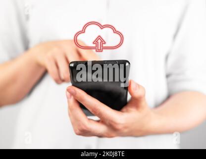 Woman holding phone for illegal file download. Online piracy concept. Unlicensed software programs, unauthorized application using. Mobile malware. Hi Stock Photo